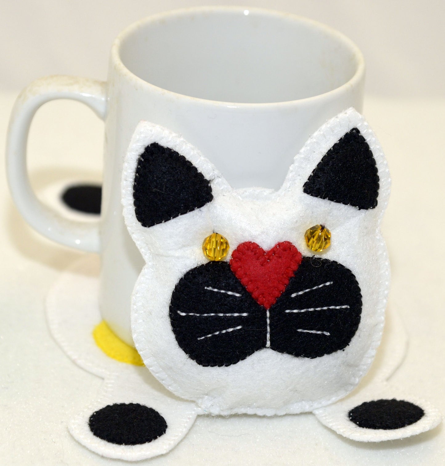 Mug Rug - White and black cat with yellow heart on back.