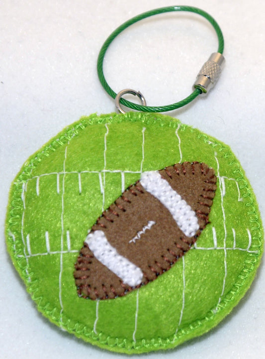 Key Ring/Backpack Charm - Football in round green field.